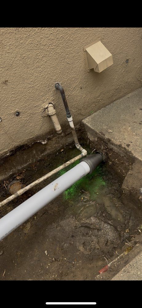 New PVC cleanout access point with dye test confirming proper drainage.